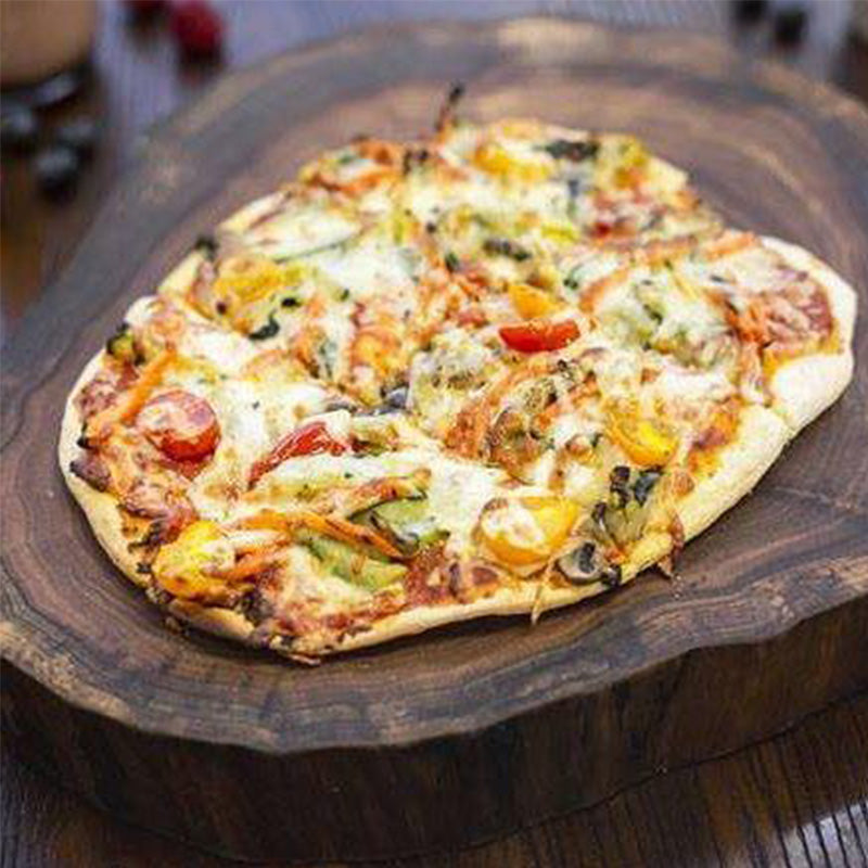 Pizza with vegan cheese, roasted red peppers, tomatoes, arugula and kale mix, with red pizza sauce.