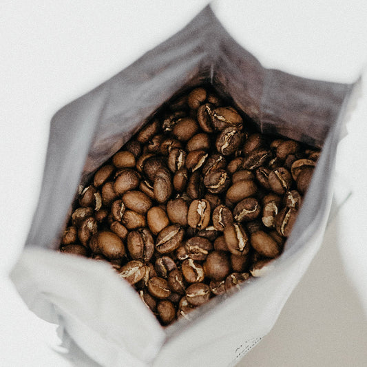 Top of open bag of whole or ground organic Peruivan coffee beans.