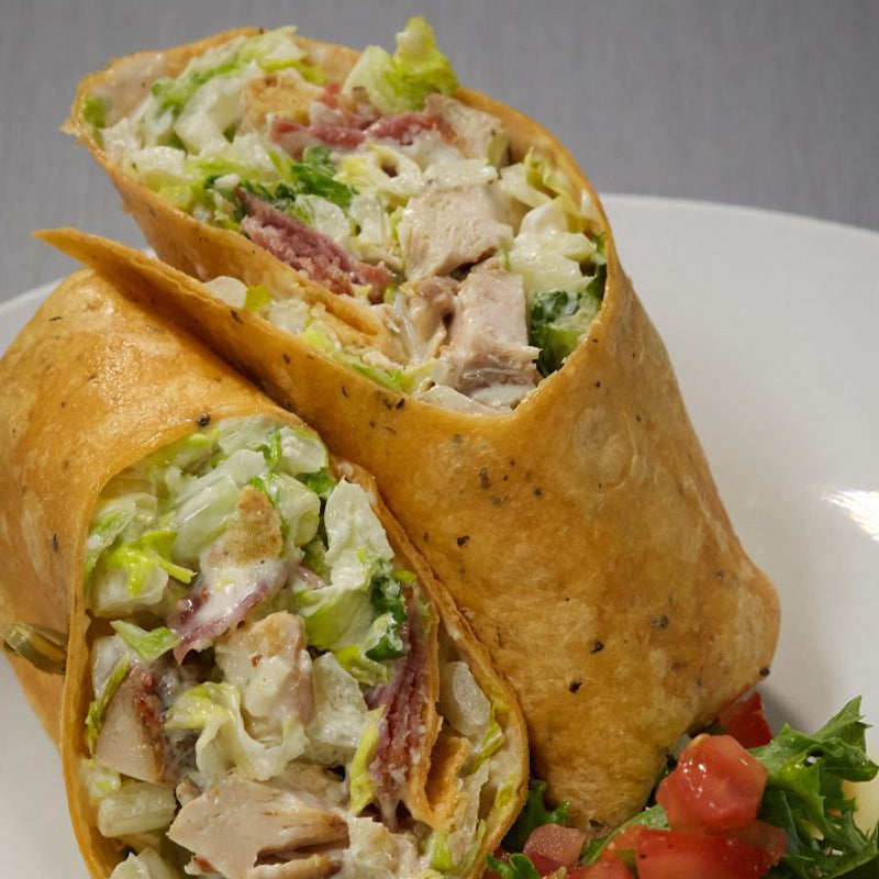 Chicken Caesar Wrap filled with chicken, bacon, tomatoes, lettuce and homemade dressing.
