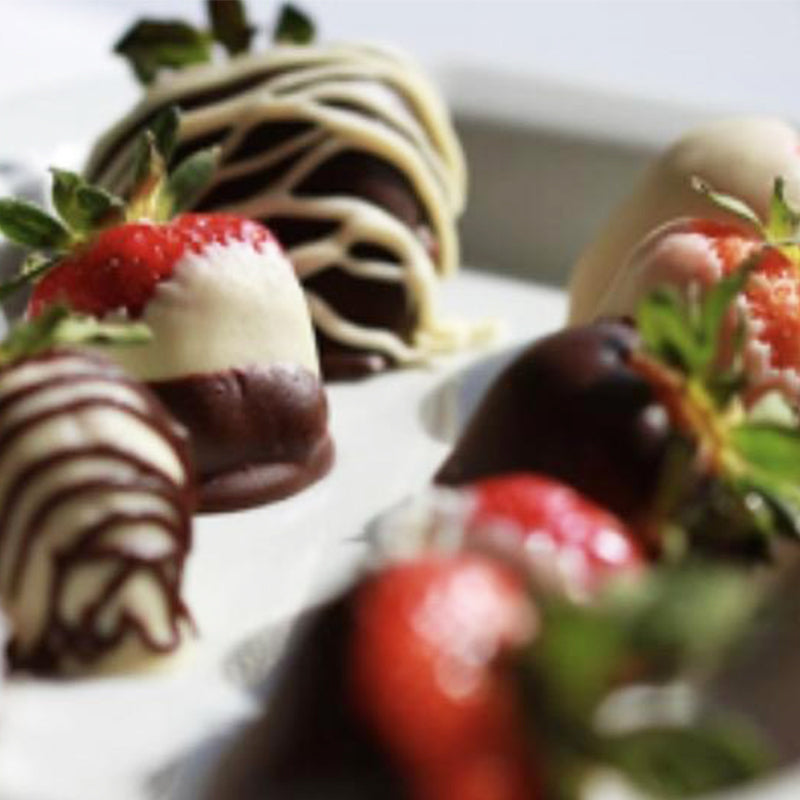 Plate of strawberries covered with various types of chocolate.