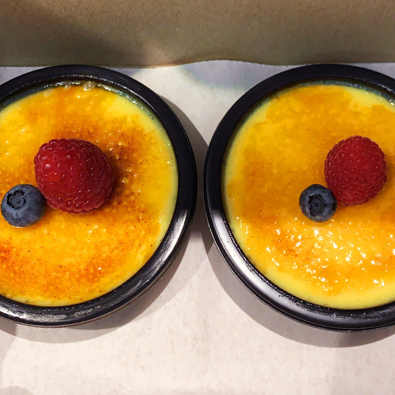 Homemade crème brûlée, made from scratch with vanilla bean, topped with seasonal fruit.