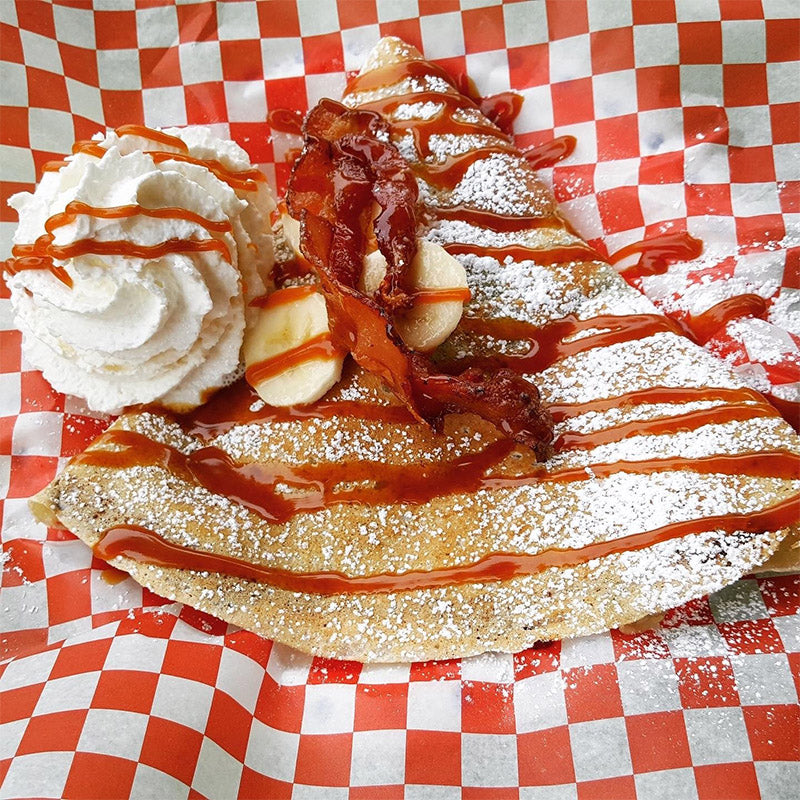 OMG crêpe filled with Nutella, bacon, bananas, caramel, whipped cream, and available as gluten free.